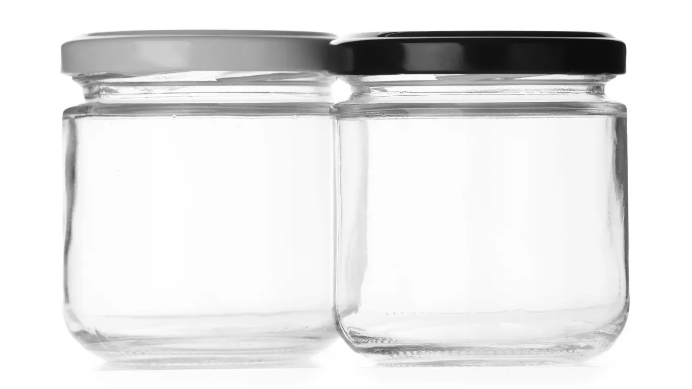Two clear ergo glass jars in bulk side by side featuring white and black metal lug caps.