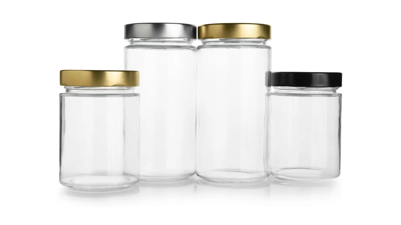 A lineup of four factory-direct paragon glass containers showcasing straight walls and assorted metal closures.