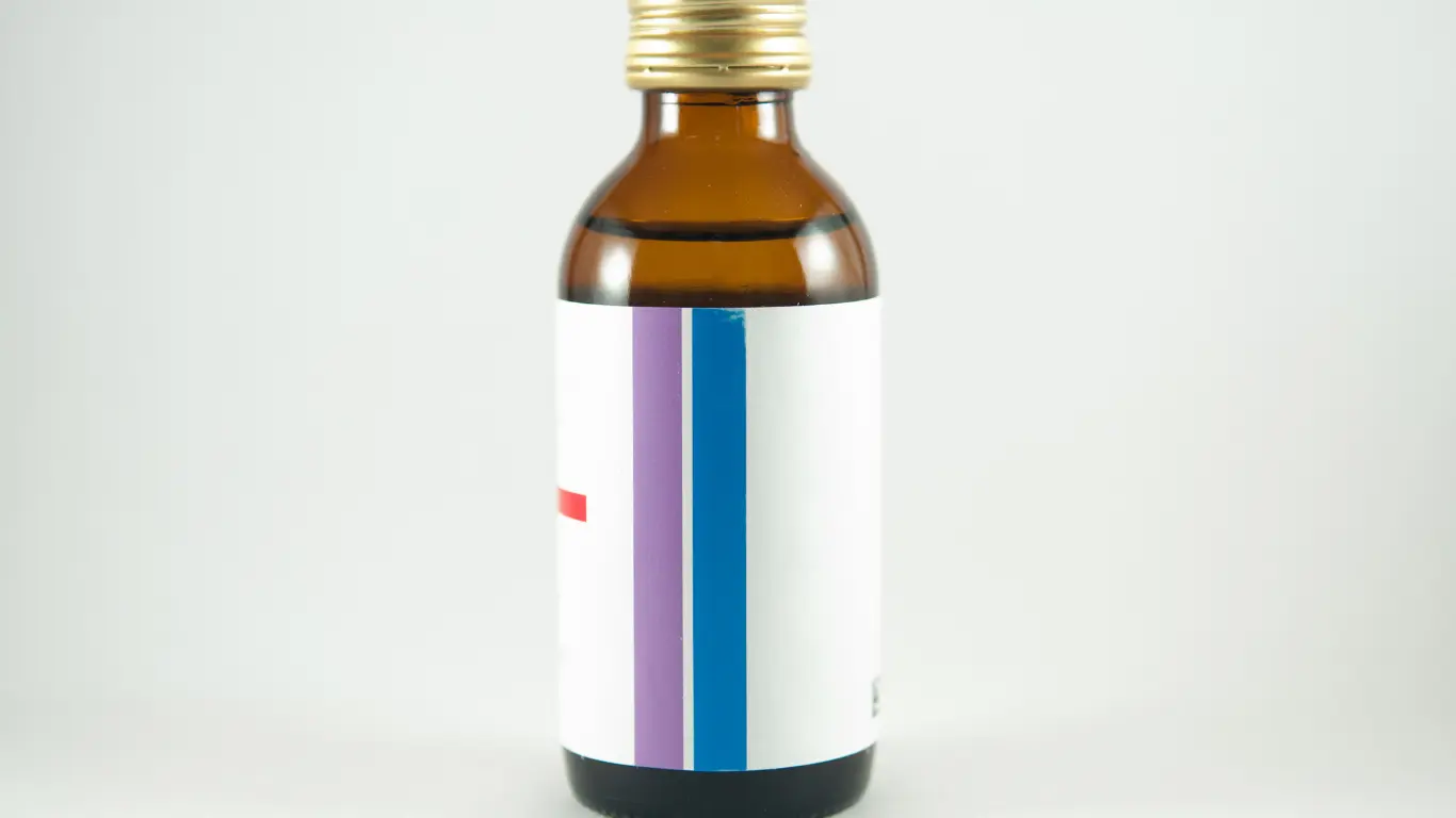 A bulk amber glass bottle for energy drinks featuring a gold metal cap and a blank customizable label.