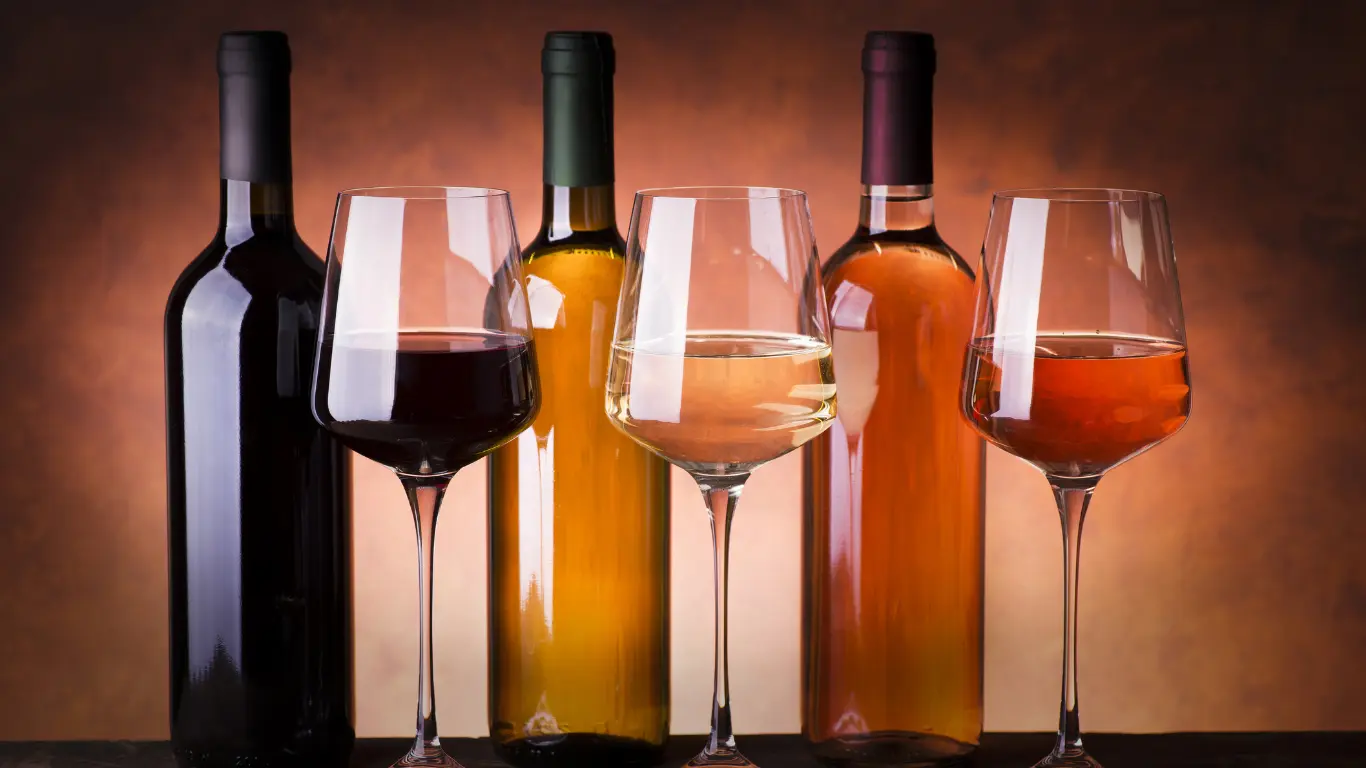 Custom bordeaux glass packaging options displayed with matching commercial stemware under ambient lighting.