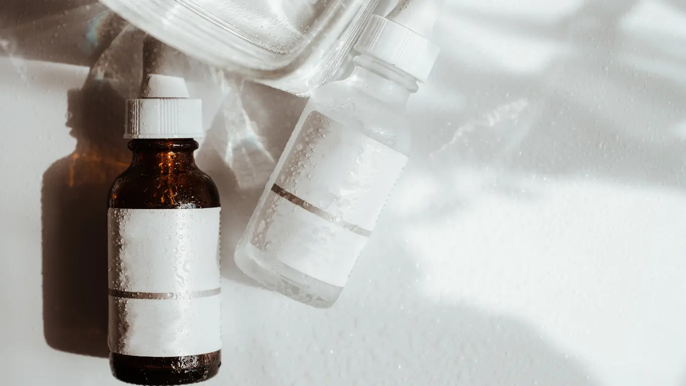 Small amber glass bottle with heavy base and black pipette assembly for face oils