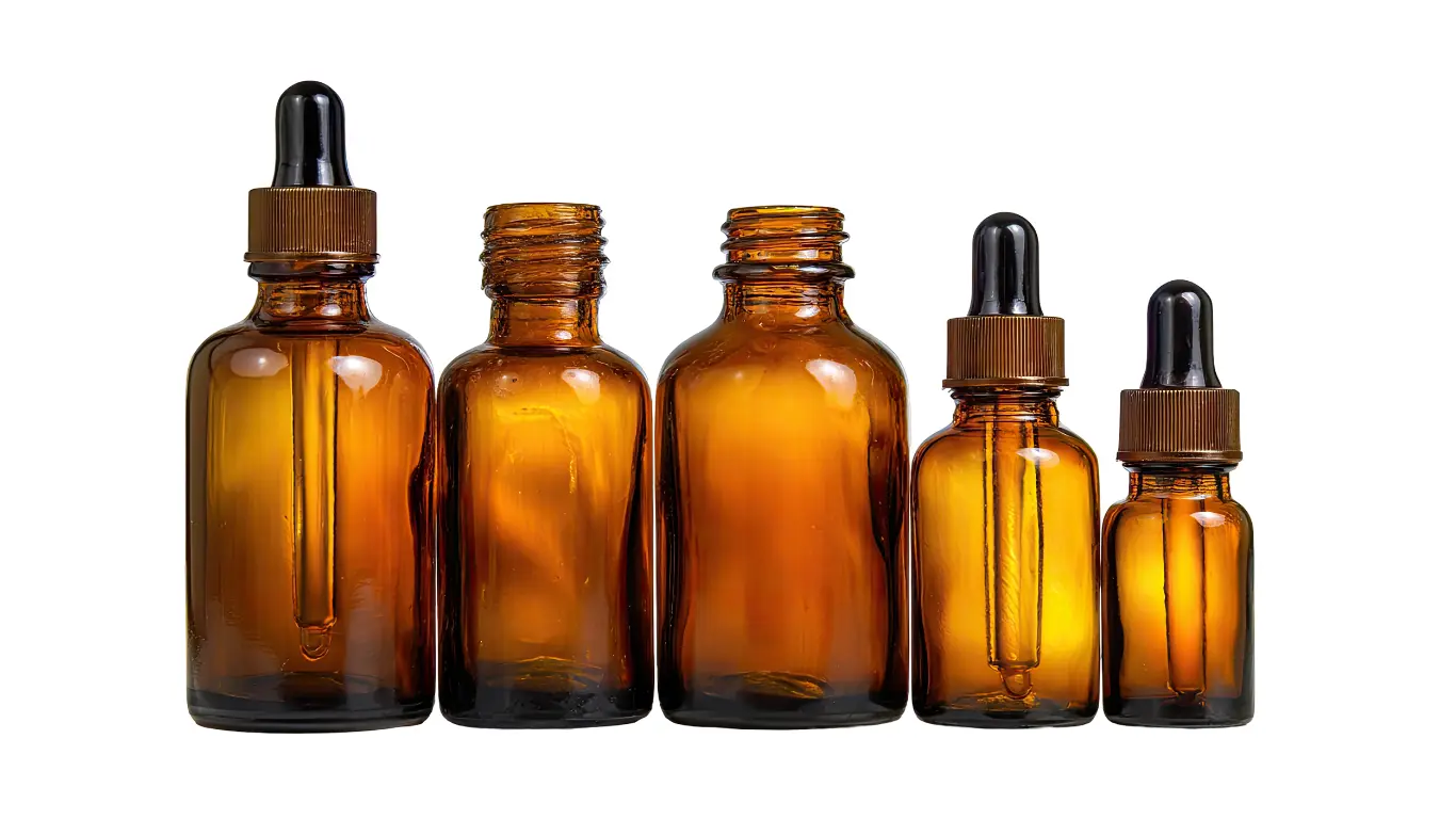Lineup of wholesale amber glass dropper bottles on studio background for commercial packaging