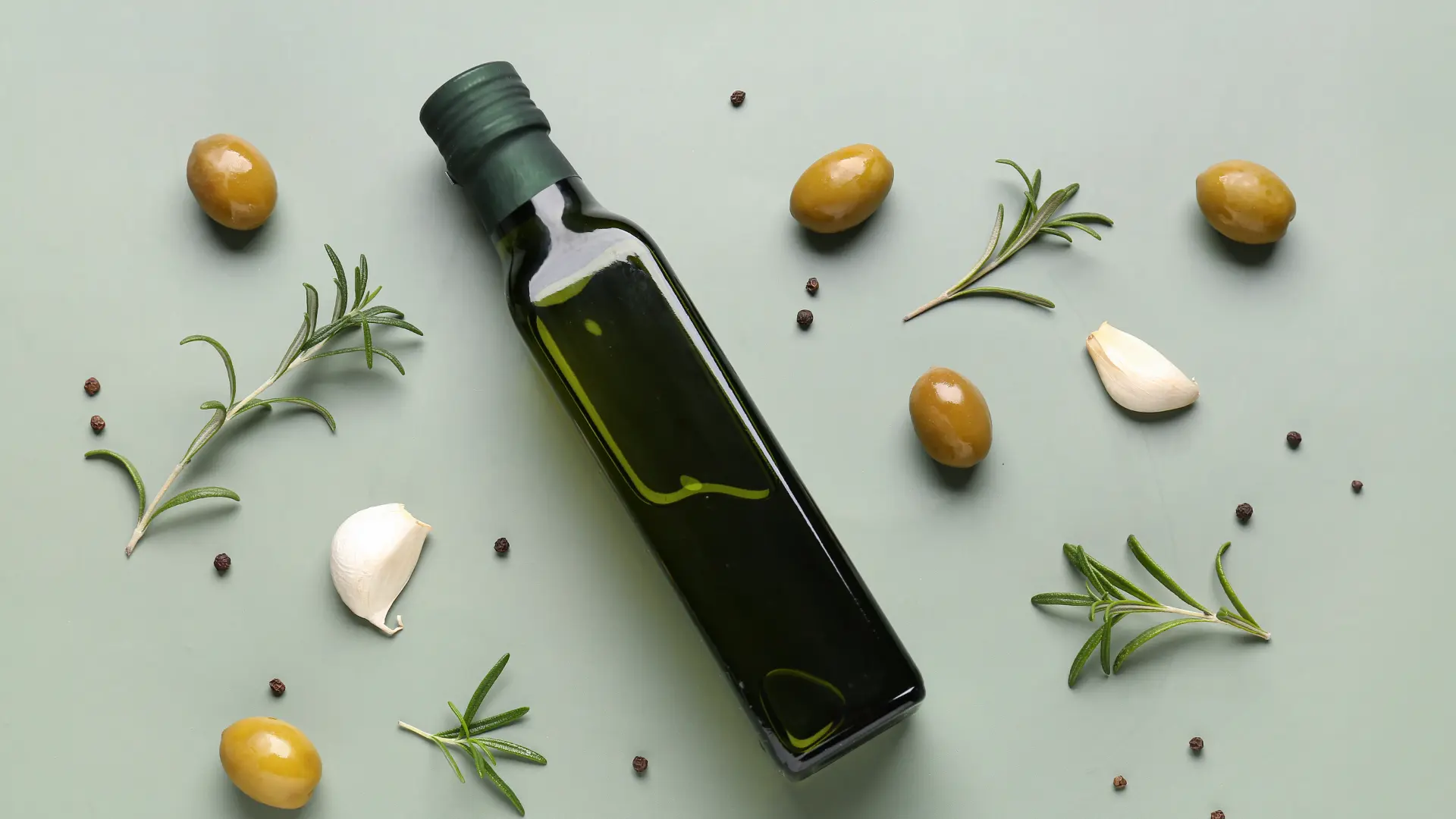 A top-down commercial view of an dark green square Marasca glass packaging container with a secure screw closure finish.